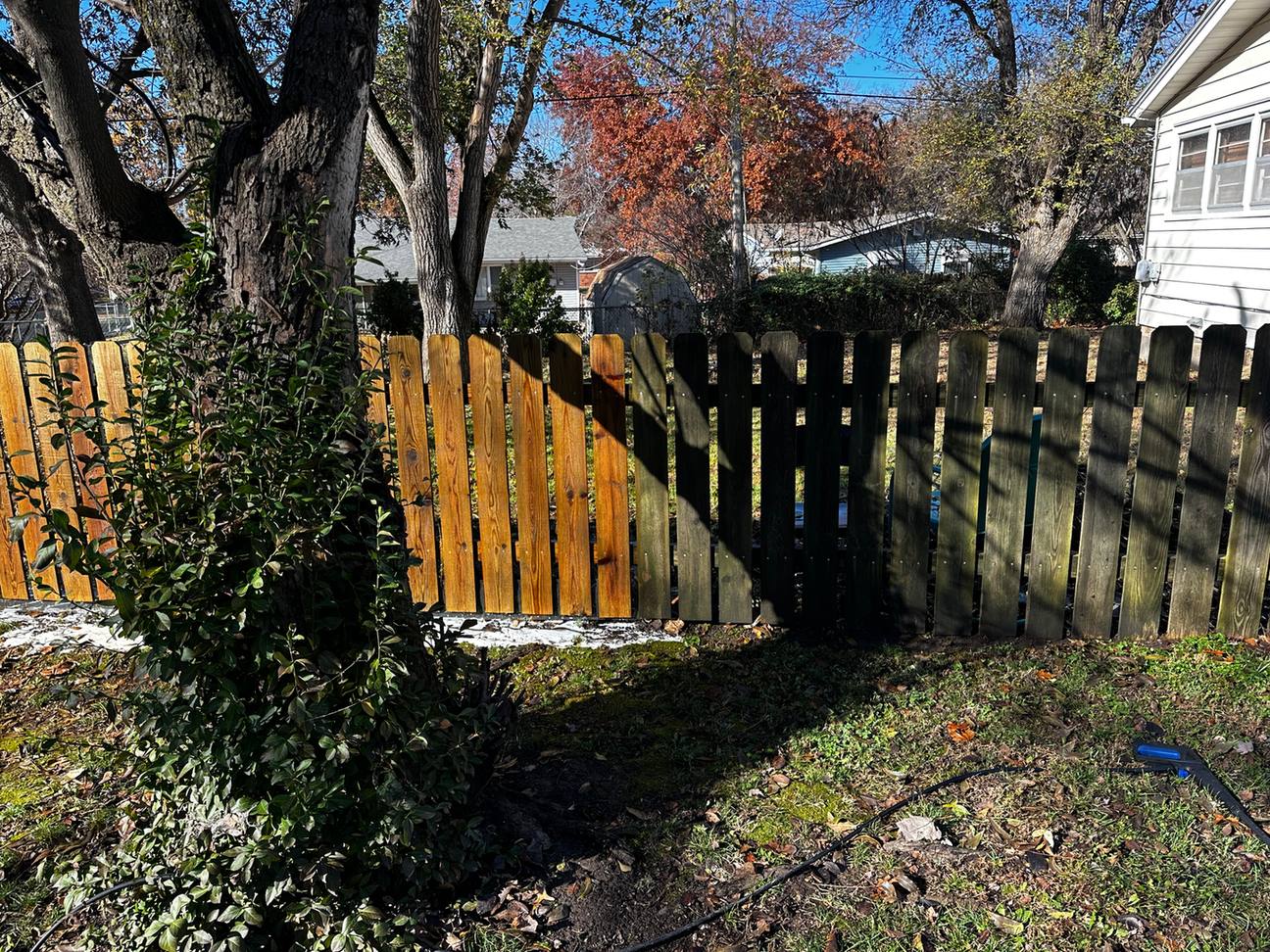 Long wood fence partly pressure washed, El Dorado, KS