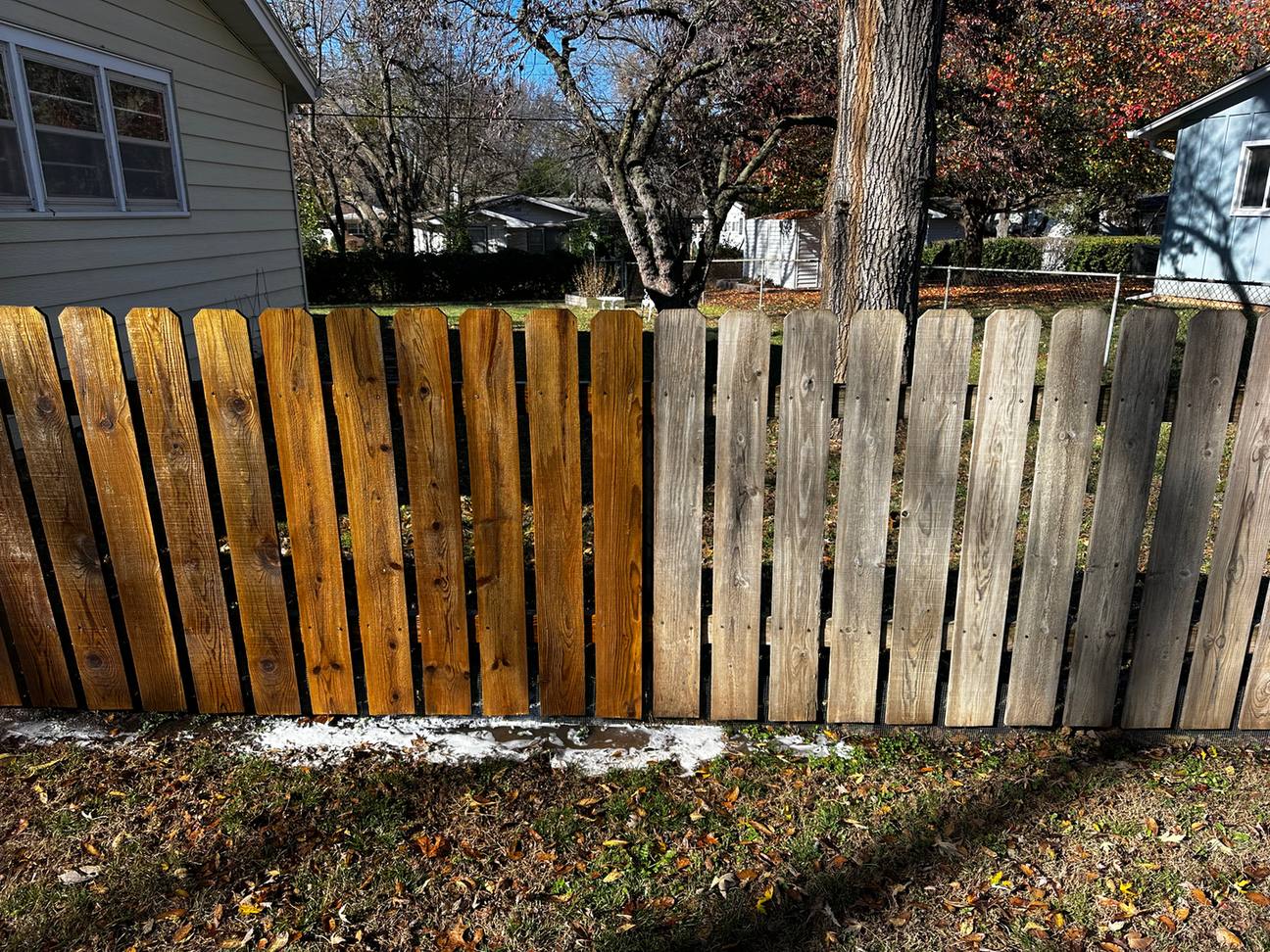Wood fence half cleaned, gray boards vs restored boards, El Dorado, KS