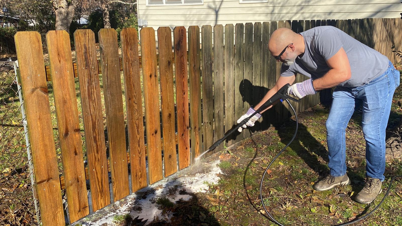 Pressure washing a wood privacy fence in El Dorado, KS
