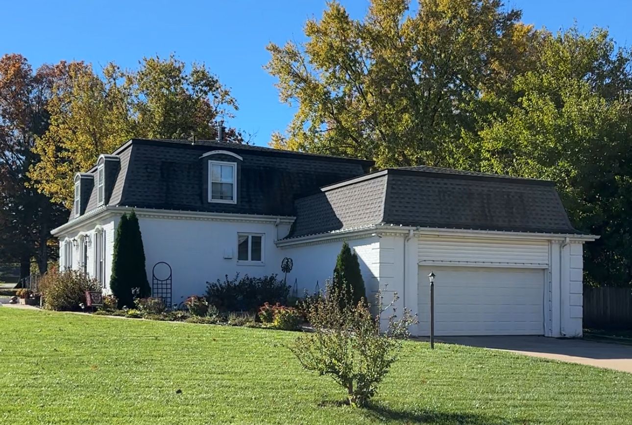 Streaked roof on a two-story home before roof cleaning, El Dorado, KS