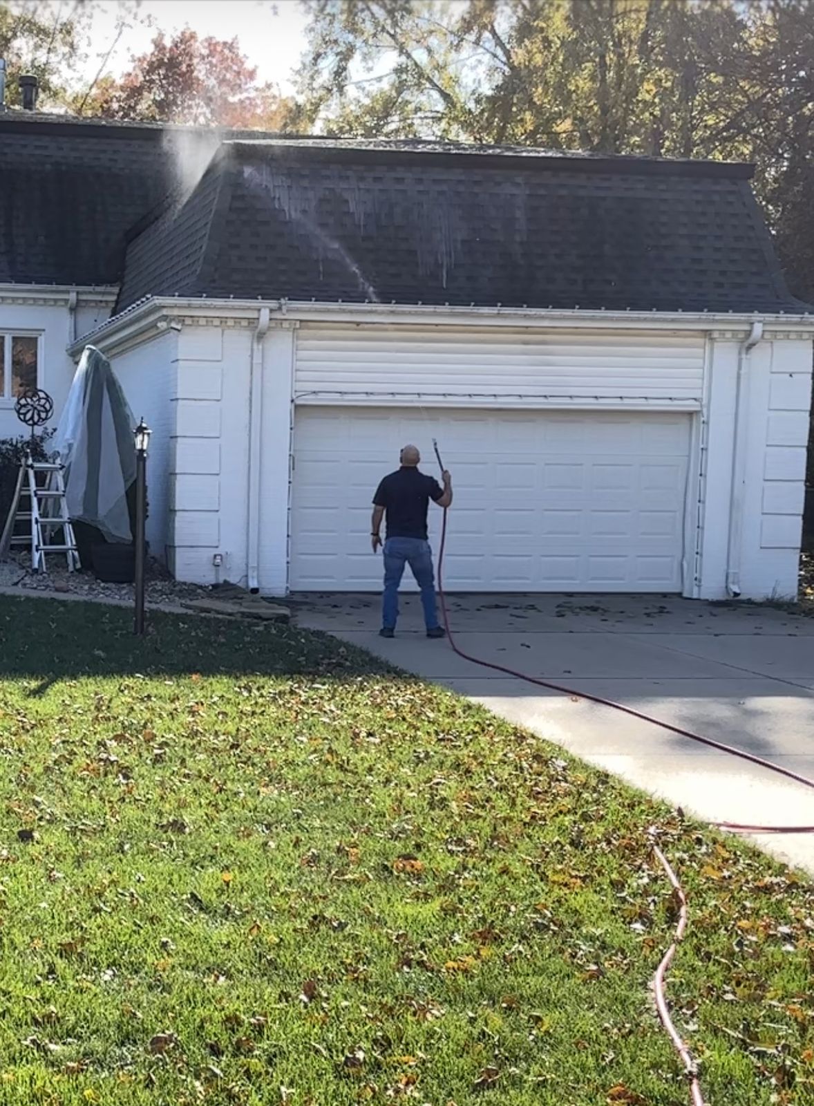 Soft washing a garage roof in El Dorado, KS
