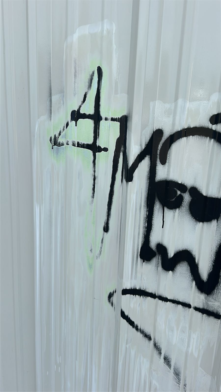 Graffiti partly removed from metal siding, Wichita, KS