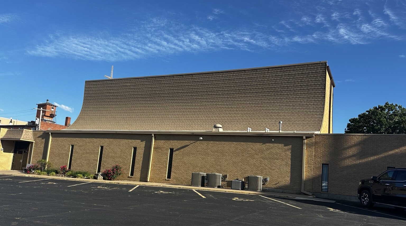 Even natural shingle color restored after church roof cleaning