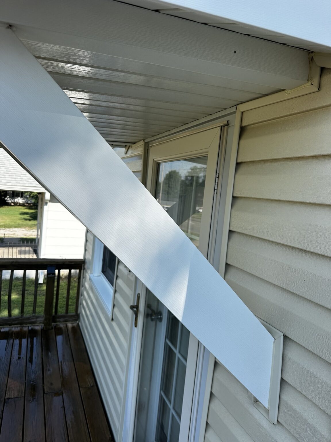 Clean white porch trim after house washing in El Dorado, Kansas