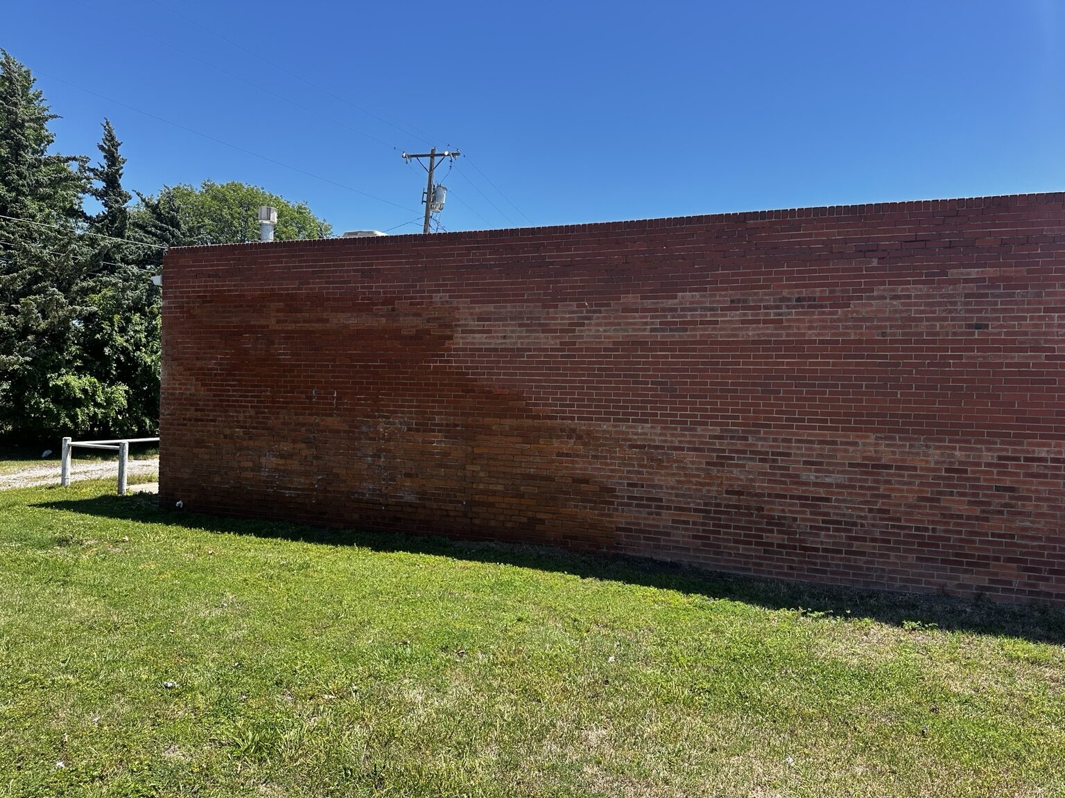 Brick wall after the large graffiti tag was removed